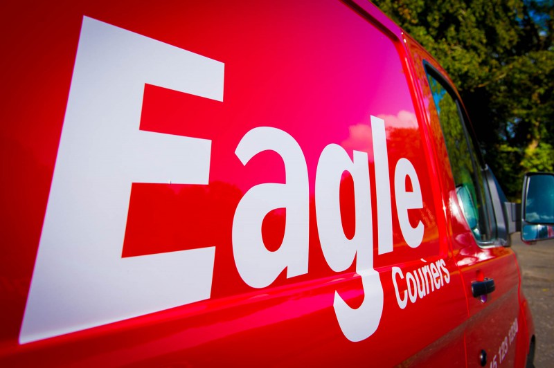The distinctive logo and red vans of Eagle Couriers